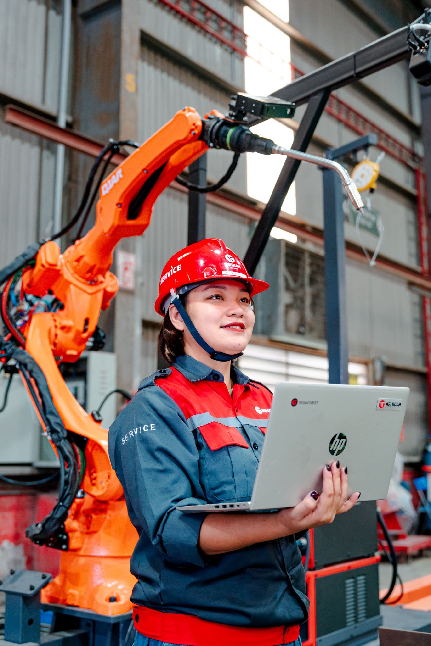 Engineer at a robotic cell — stock photograph